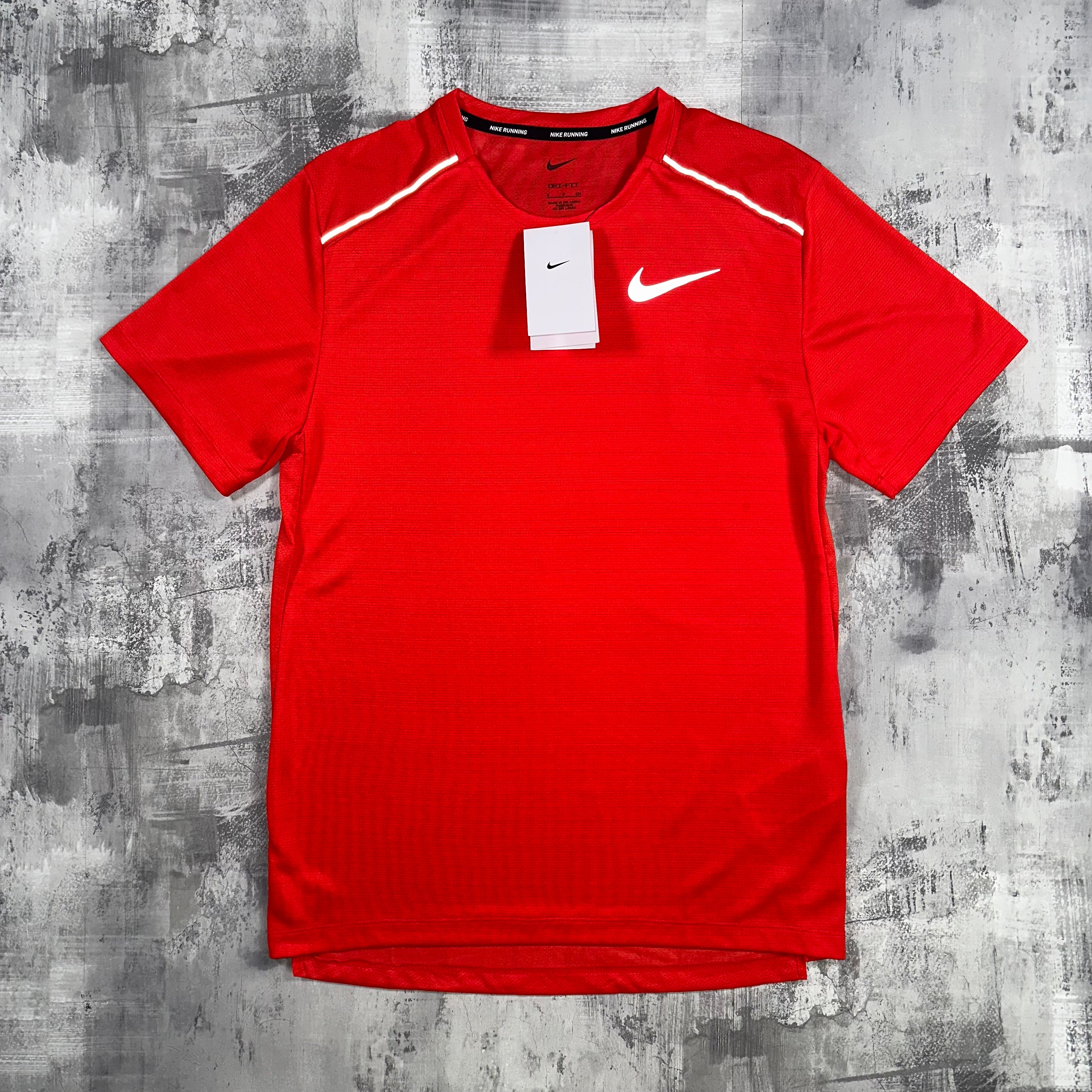 The Nike Miler T-Shirt in Red. In this angle you can see the signature Nike swoosh across the chest.
